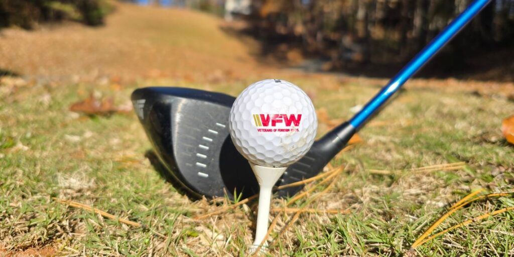 golf ball with VFW logo on it, teed up on a Par 5